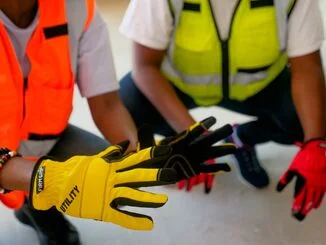 Industrial workers wearing protective gloves